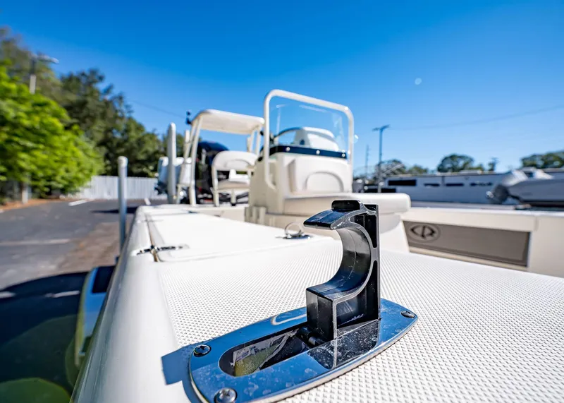 Slide: The Image of 2024 Spyder FX 19 Vapor boat deck with chrome hardware, sunny day, outdoor setting. - 23