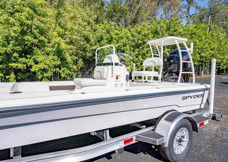 Slide: The Image of 2024 Spyder FX 19 Vapor boat on trailer, surrounded by lush greenery. - 5
