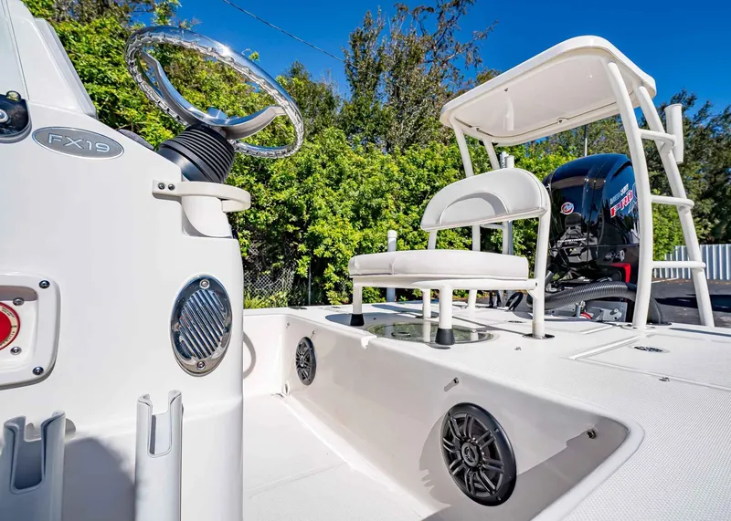 Slide: The Image of 2024 Spyder FX 19 Vapor boat interior with steering wheel and seating, showcasing modern design. - 8