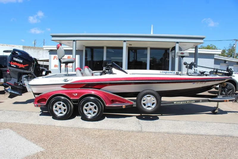 Slide: The Image of 2007 Ranger Z21 boat with Yamaha engine, parked on a trailer outside a building. - 1