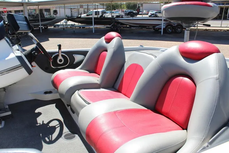 Slide: The Image of 2007 Ranger Z21 boat interior with red and gray seats, steering wheel, and control panel. - 14