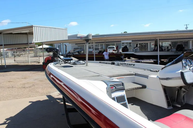 Slide: The Image of 2007 Ranger Z21 boat parked outdoors under clear blue sky. - 18