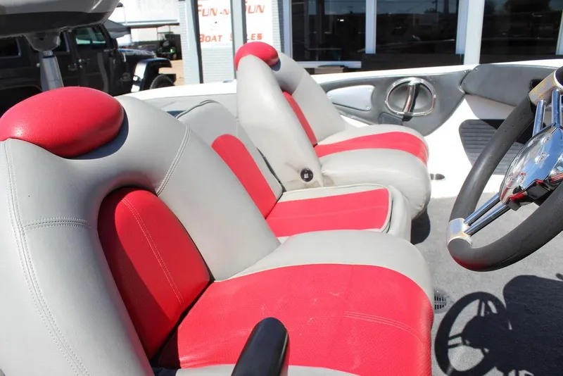 Slide: The Image of 2007 Ranger Z21 boat interior with red and gray seats, steering wheel visible. - 21