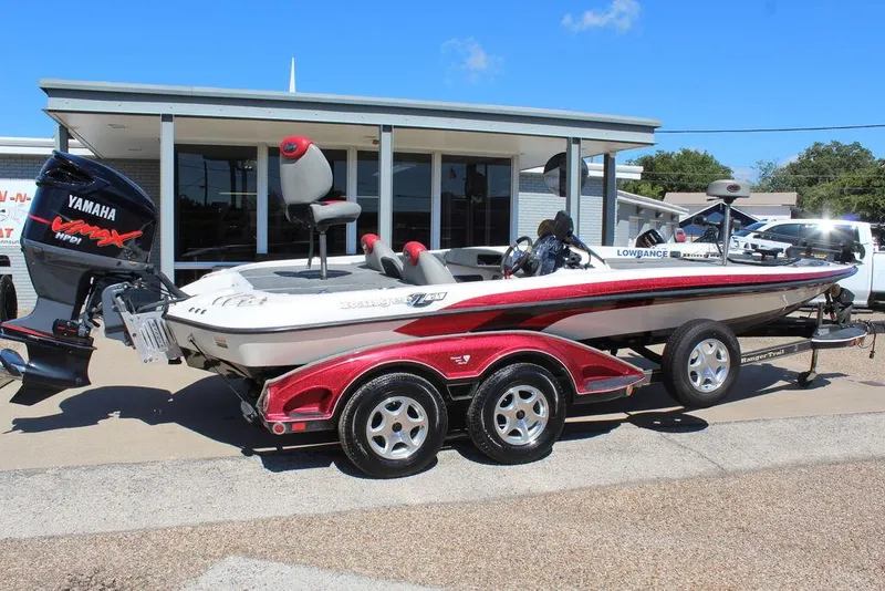 Slide: The Image of 2007 Ranger Z21 boat with Yamaha engine, parked on a trailer outside a building. - 3
