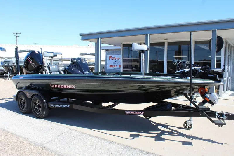 The Image of 2025 Phoenix 920 Elite II boat on trailer, parked outside dealership. - 0