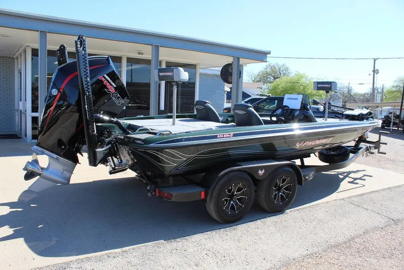 Slide: The Image of 2025 Phoenix 920 Elite II boat on trailer, parked outside dealership. - 1