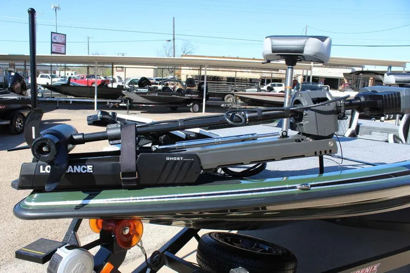 Slide: The Image of 2025 Phoenix 920 Elite II boat with Lowrance Ghost trolling motor, parked outdoors. - 11