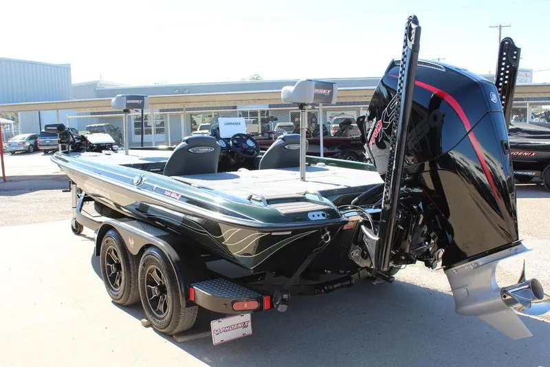 Slide: The Image of 2025 Phoenix 920 Elite II boat with powerful outboard motor, parked on a trailer. - 5