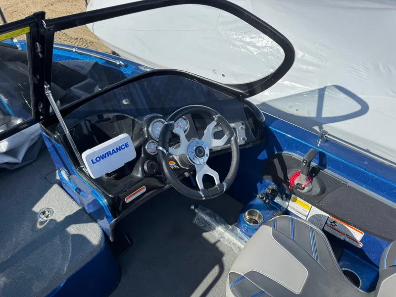 Slide: The Image of 2024 Nitro ZV19 Sport boat cockpit with steering wheel and Lowrance electronics. - 12