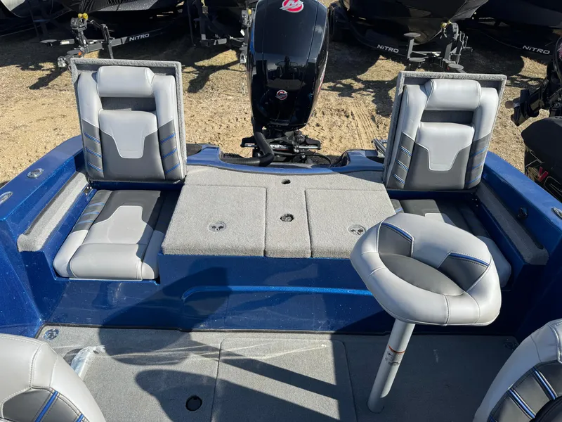 Slide: The Image of 2024 Nitro ZV19 Sport boat interior with gray seating and motor. - 14