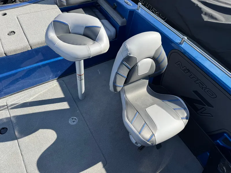 Slide: The Image of 2024 Nitro ZV19 Sport boat seats with gray and blue accents. - 16