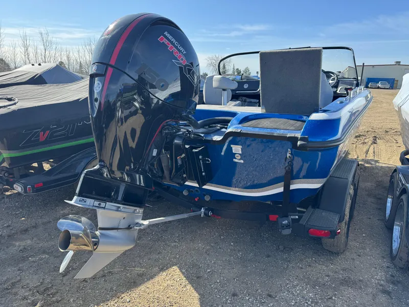 Slide: The Image of 2024 Nitro ZV19 Sport boat with powerful outboard motor, parked on a trailer. - 2