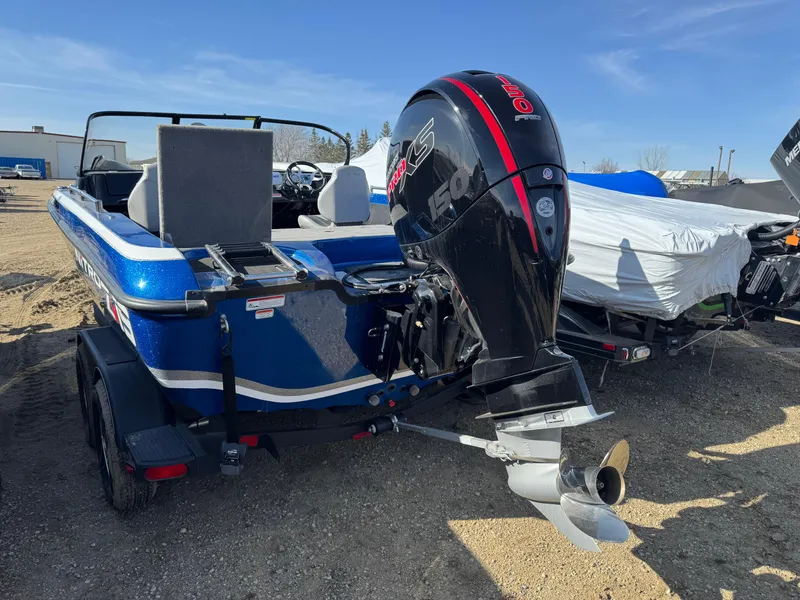 Slide: The Image of 2024 Nitro ZV19 Sport boat with powerful outboard motor, parked on a trailer. - 3