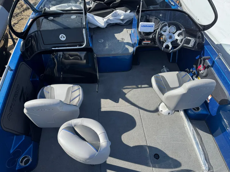 Slide: The Image of 2024 Nitro ZV19 Sport boat interior with gray seats and steering console. - 5