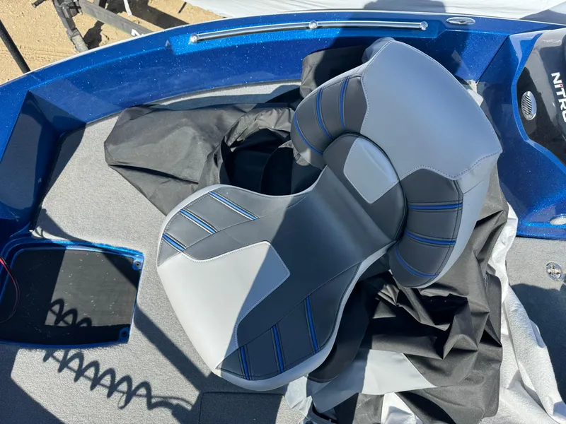Slide: The Image of 2024 Nitro ZV19 Sport boat seat with blue accents and protective cover. - 7