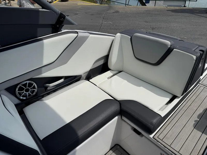 Slide: The Image of 2021 Yamaha Boats 252SE interior seating with sleek black and white upholstery. - 11
