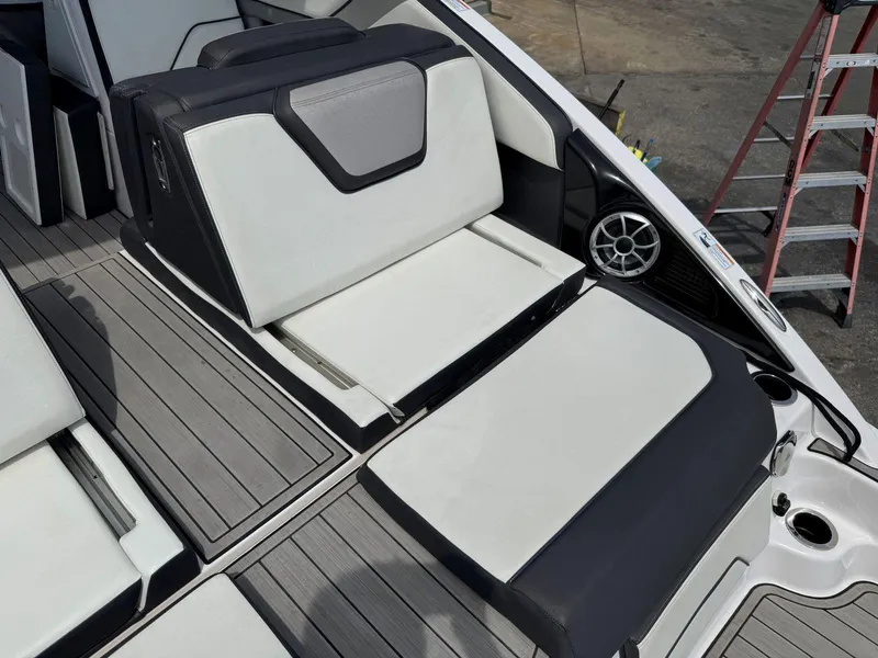 Slide: The Image of 2021 Yamaha Boats 252SE interior seating with modern design and speaker system. - 18
