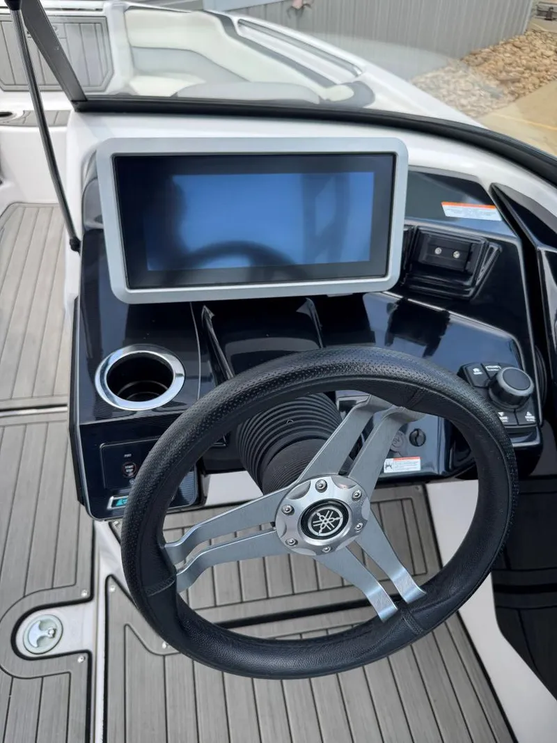 Slide: The Image of 2021 Yamaha Boats 252SE dashboard with steering wheel and touchscreen display. - 30