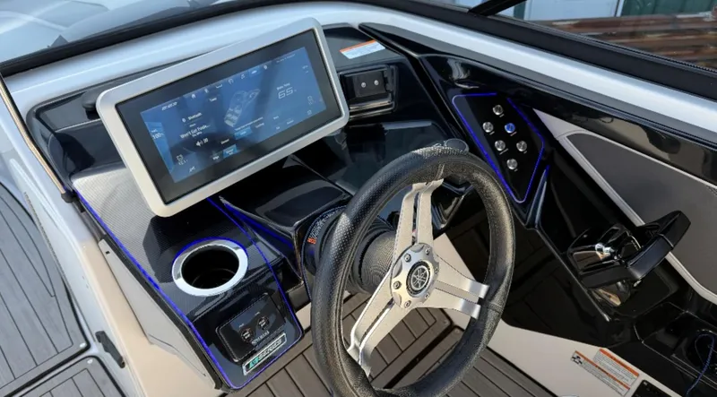 Slide: The Image of 2021 Yamaha Boats 252SE dashboard with touchscreen, steering wheel, and controls. - 32