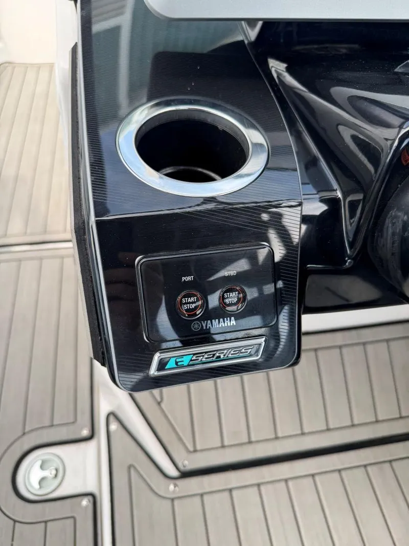 Slide: The Image of 2021 Yamaha Boats 252SE control panel with cup holder on deck. - 35