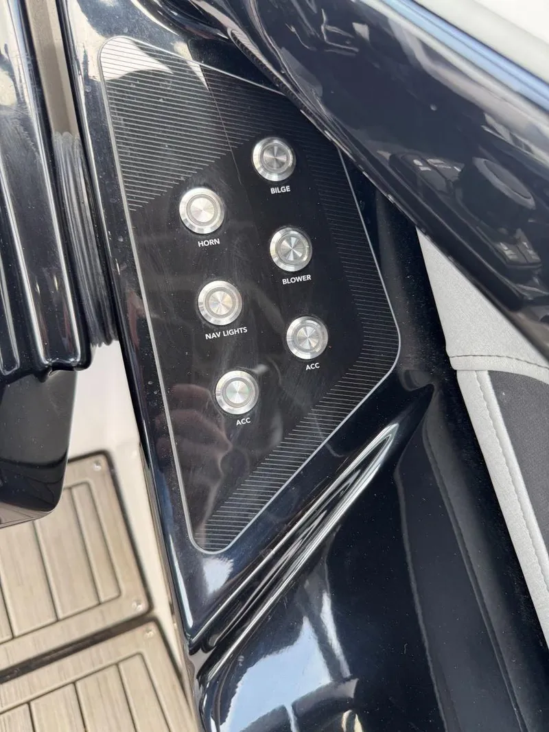 Slide: The Image of Control panel of 2021 Yamaha Boats 252SE with various switches. - 37