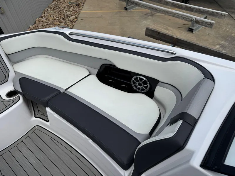 Slide: The Image of 2021 Yamaha Boats 252SE interior seating with sleek design and integrated speaker system. - 40