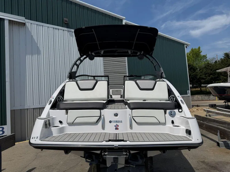 Slide: The Image of 2021 Yamaha Boats 252SE with sleek design, docked outdoors under blue sky. - 7