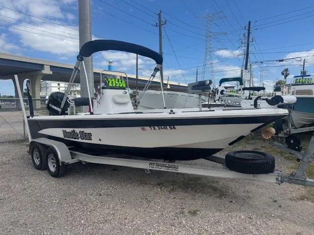 The Image of 2010 NauticStar 2110 Nautic Bay boat on trailer, displayed outdoors. - 0