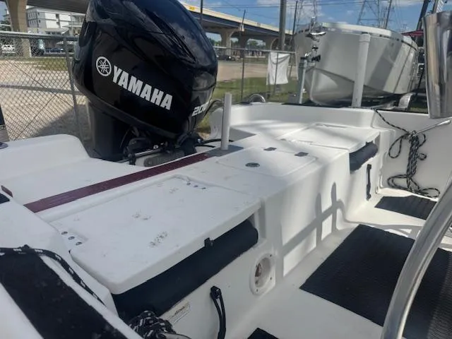 Slide: The Image of 2010 NauticStar 2110 Nautic Bay boat with Yamaha 200 engine, docked outdoors. - 11