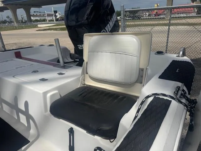 Slide: The Image of 2010 NauticStar 2110 Nautic Bay boat with Yamaha engine, featuring seating and deck details. - 13