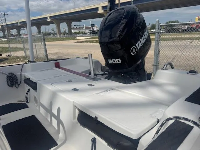 Slide: The Image of 2010 NauticStar 2110 Nautic Bay boat with Yamaha 200 engine, parked near a highway. - 14