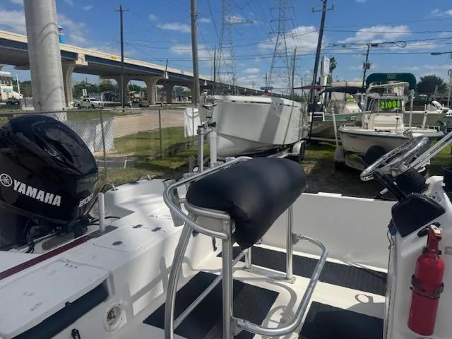 Slide: The Image of 2010 NauticStar 2110 Nautic Bay boat with Yamaha engine, parked outdoors under blue sky. - 18