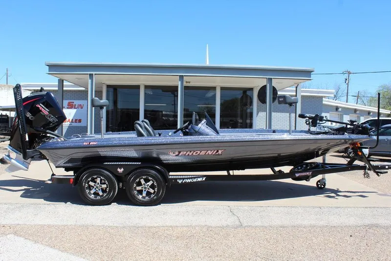 Slide: The Image of 2025 Phoenix 921 ELITE boat on trailer, parked outside dealership. - 1