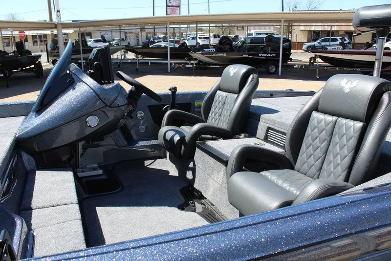 Slide: The Image of 2025 Phoenix 921 ELITE boat interior with sleek seats and modern dashboard. - 13