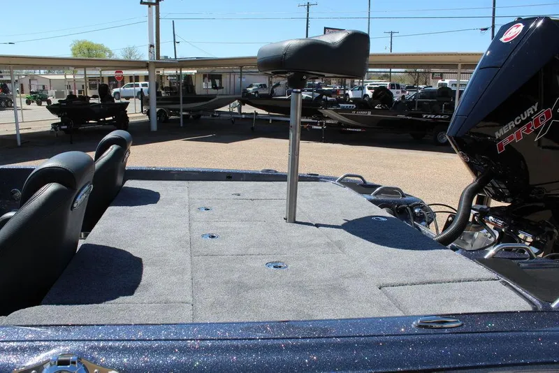 Slide: The Image of 2025 Phoenix 921 ELITE boat with spacious deck and Mercury engine in a showroom. - 14