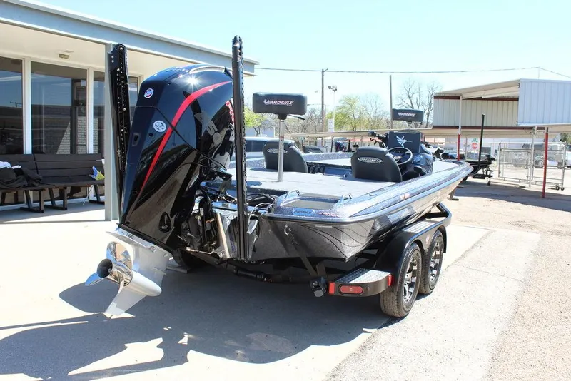 Slide: The Image of 2025 Phoenix 921 ELITE boat on trailer, parked outdoors, showcasing sleek design and powerful engine. - 3
