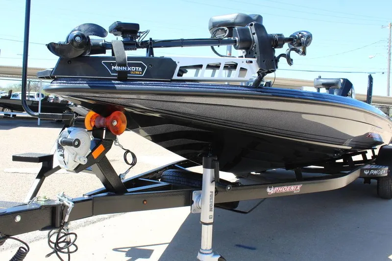 Slide: The Image of 2025 Phoenix 921 ELITE boat on trailer with Minn Kota motor, parked outdoors. - 8