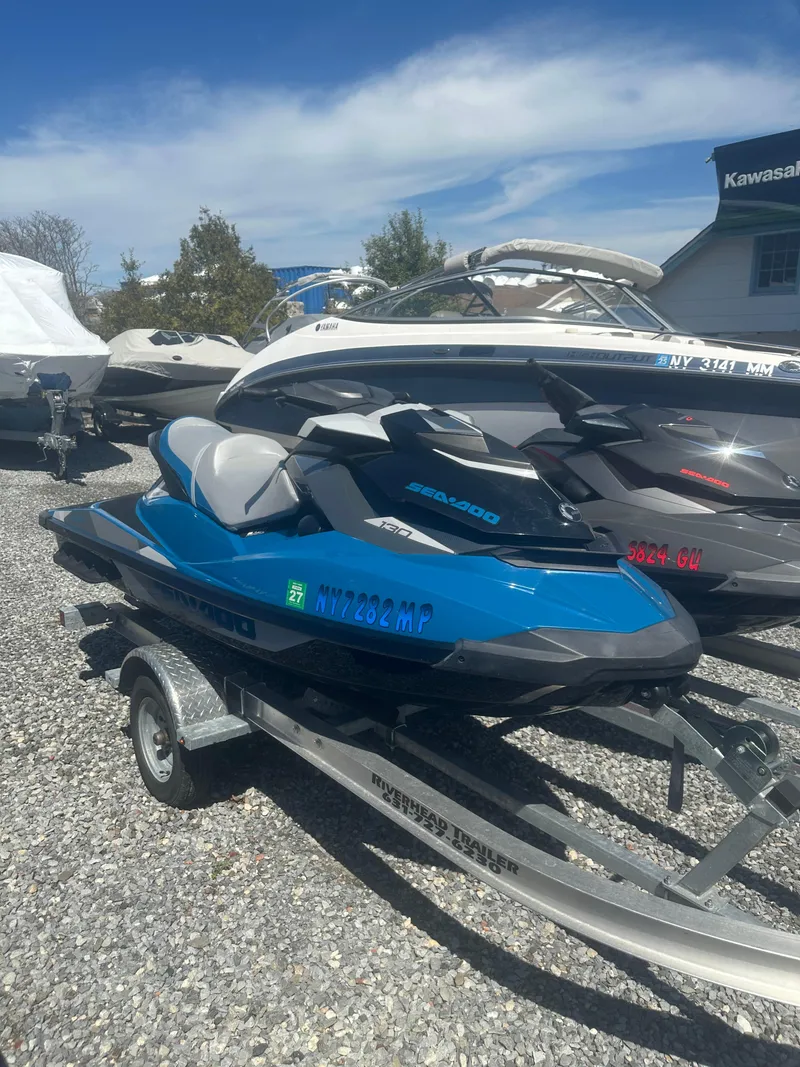 Slide: The Image of 2019 Sea-Doo GTI SE 130 jet ski on trailer, parked outdoors. - 4