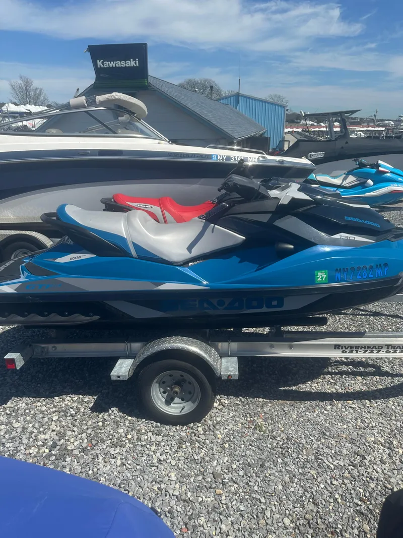 Slide: The Image of 2019 Sea-Doo GTI SE 130 jet ski on trailer, parked outdoors. - 5