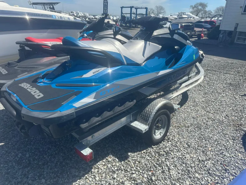 Slide: The Image of 2019 Sea-Doo GTI SE 130 jet ski on trailer, parked on gravel lot. - 7