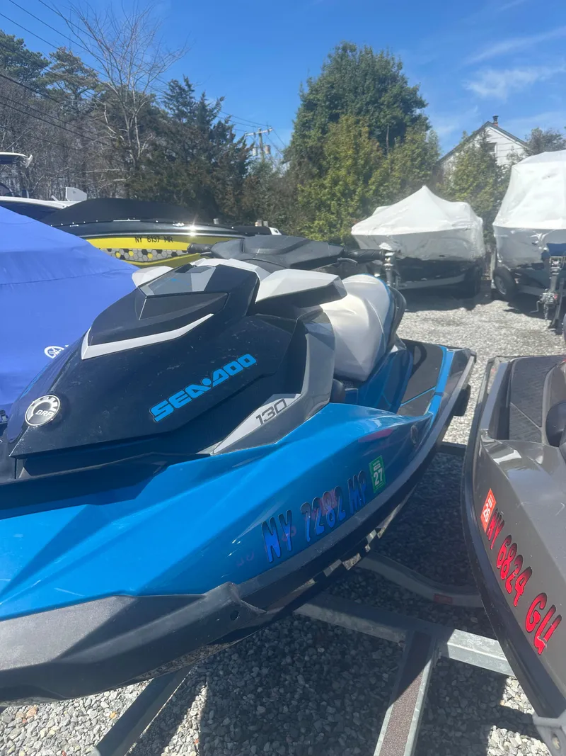 Slide: The Image of 2019 Sea-Doo GTI SE 130 jet ski in blue, parked on a trailer. - 8