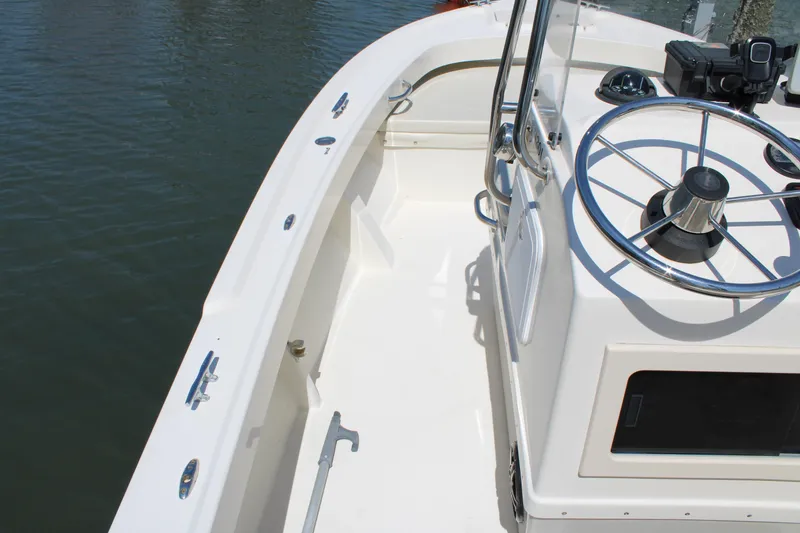 Slide: The Image of 2006 Parker 1801 Center Console boat with steering wheel, docked on calm water. - 12