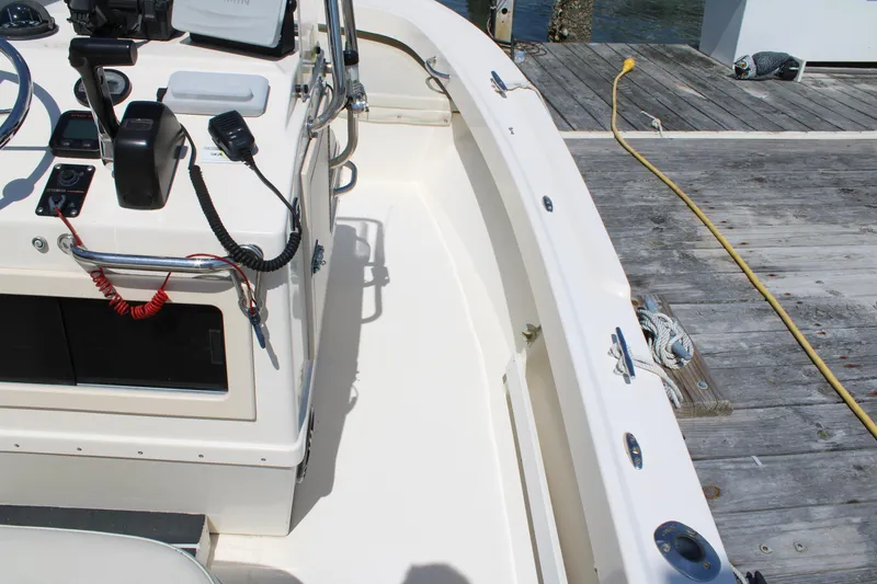 Slide: The Image of 2006 Parker 1801 Center Console boat docked, showcasing control panel and deck details. - 13