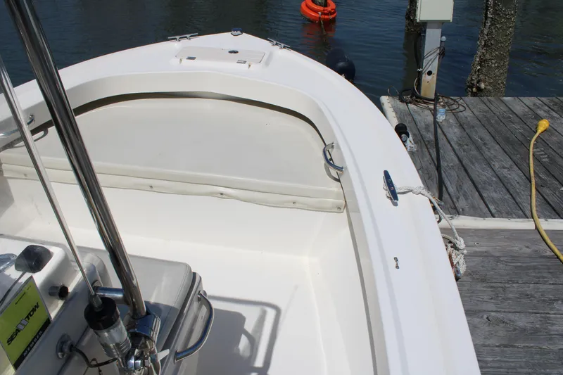 Slide: The Image of 2006 Parker 1801 Center Console boat docked by the water. - 14