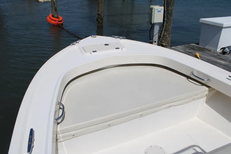 Slide: The Image of 2006 Parker 1801 Center Console boat, white deck, docked by water with life ring. - 16