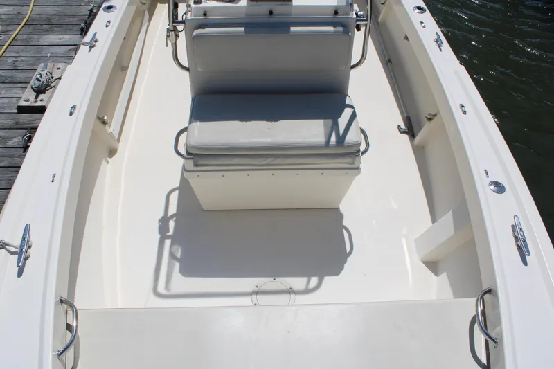 Slide: The Image of 2006 Parker 1801 Center Console boat interior with seating and console, docked by water. - 19