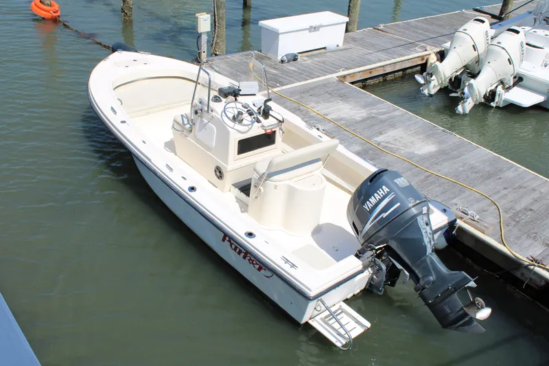 Slide: The Image of 2006 Parker 1801 Center Console boat docked with Yamaha outboard motor. - 2