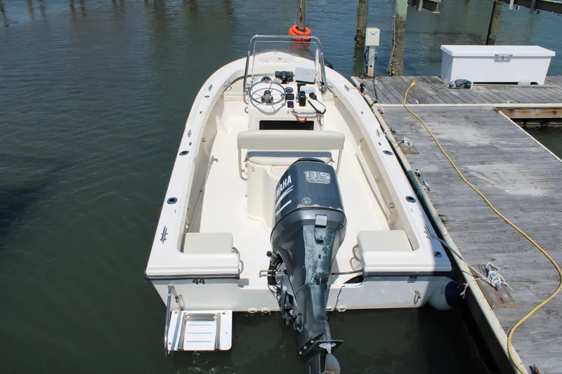 Slide: The Image of 2006 Parker 1801 Center Console boat docked, featuring an outboard motor and spacious deck. - 4