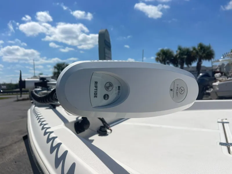 Slide: The Image of Bulls Bay 2400 boat with Riptide motor, 2020 model, under clear blue sky. - 13