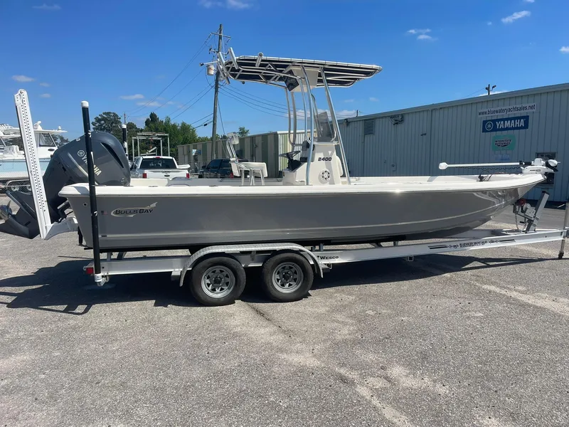 Slide: The Image of 2020 Bulls Bay 2400 boat on trailer, parked outdoors under clear blue sky. - 2